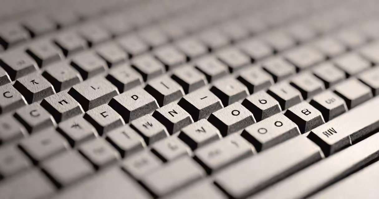 A close-up of a keyboard focusing on the semicolon key and punctuation marks