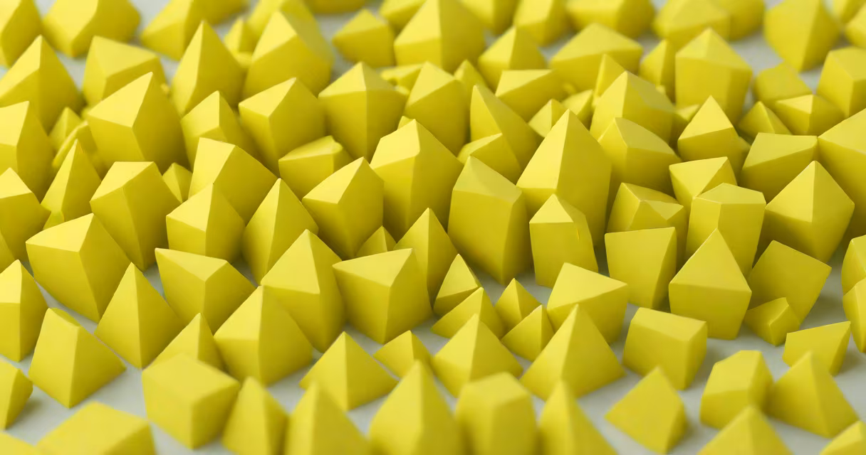 Yellow crystalline sulfur crystals on a white background